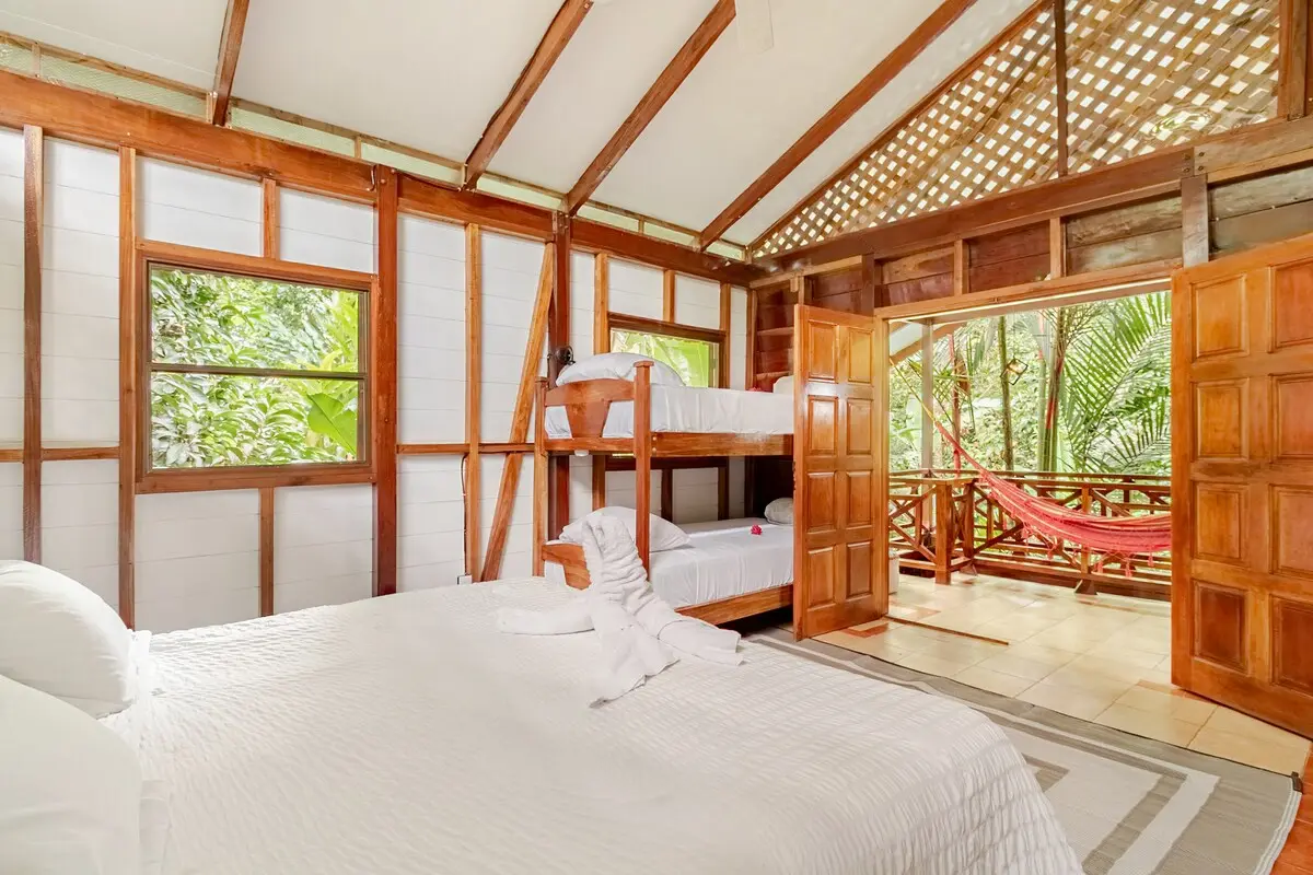 A bedroom with a king bed and a bunk bed