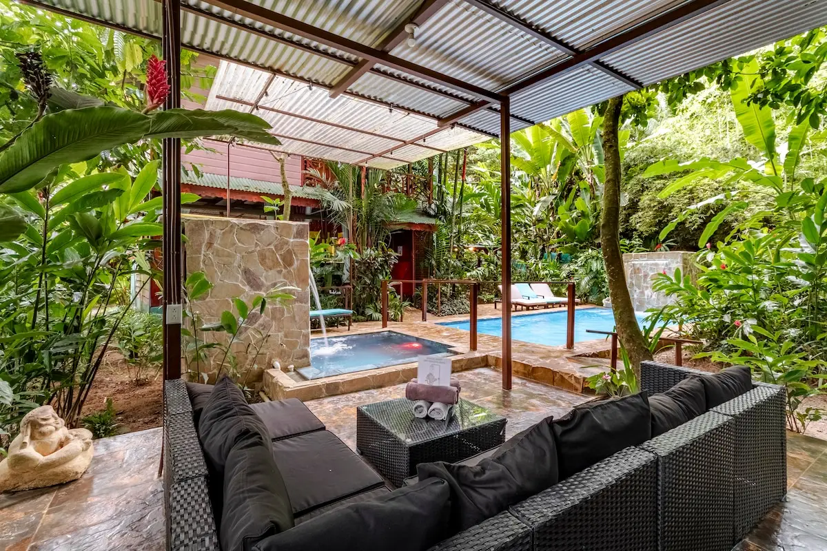 The pool and covered hot tub in daylight